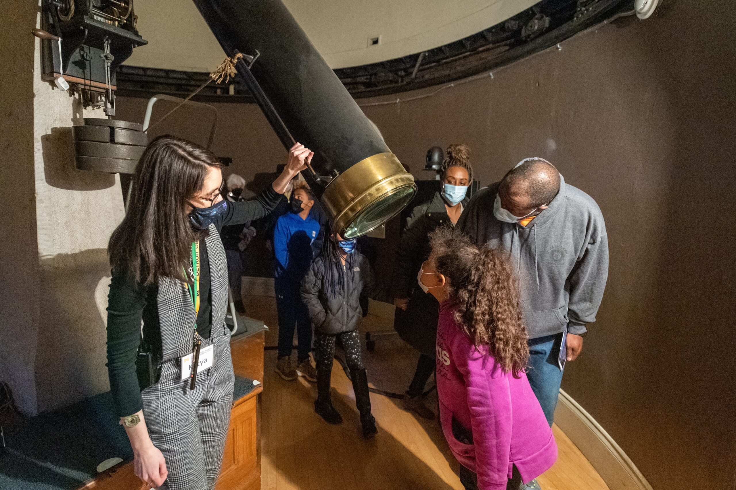 Image of student docent showing young child the Fitz telescope.